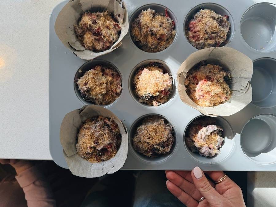 Muffins in paper-lined pan before baking.
