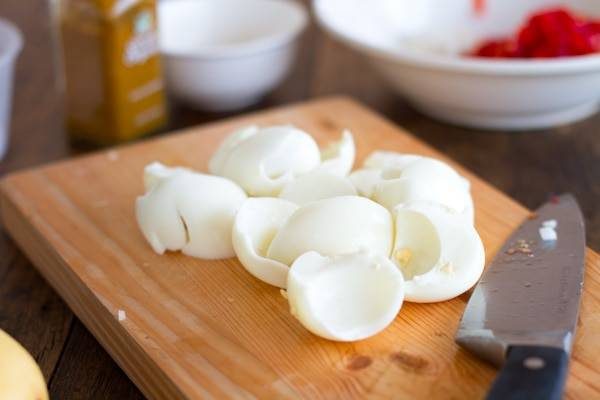 Sliced eggs on a cutting board.