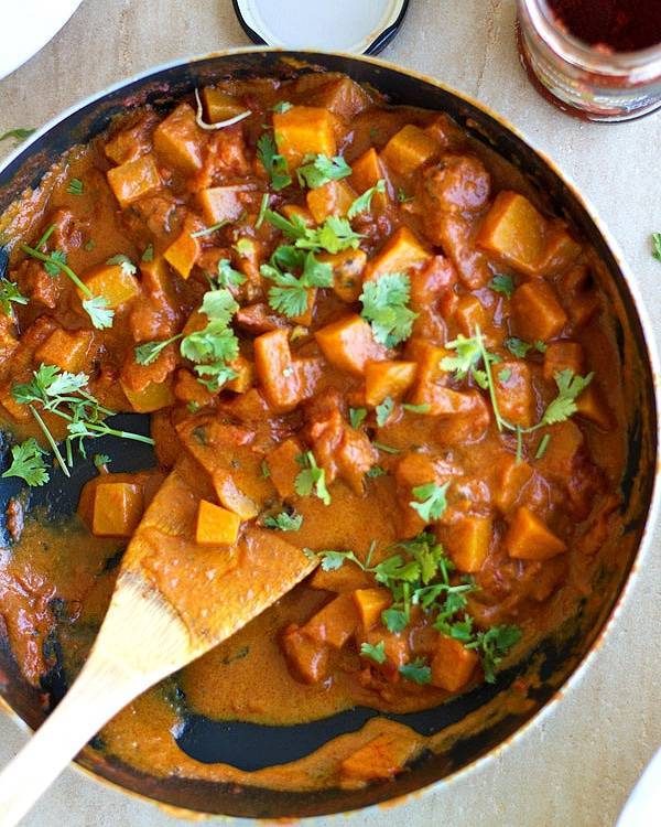 Squash coconut curry in a skillet.