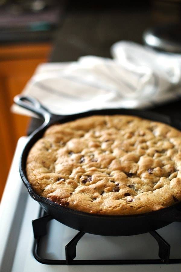 Deep Dish Chocolate Chip Cookie in a skillet on the oven.