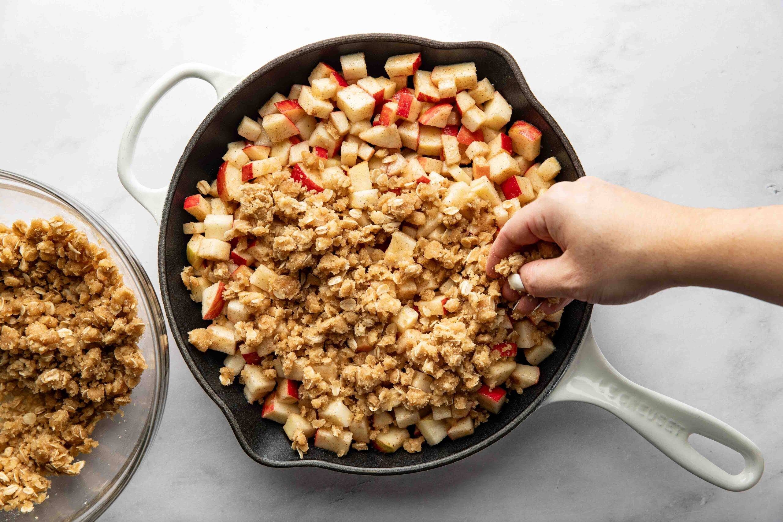 Spreading crumb topping on apples.