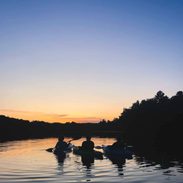 People canoeing at sunset.