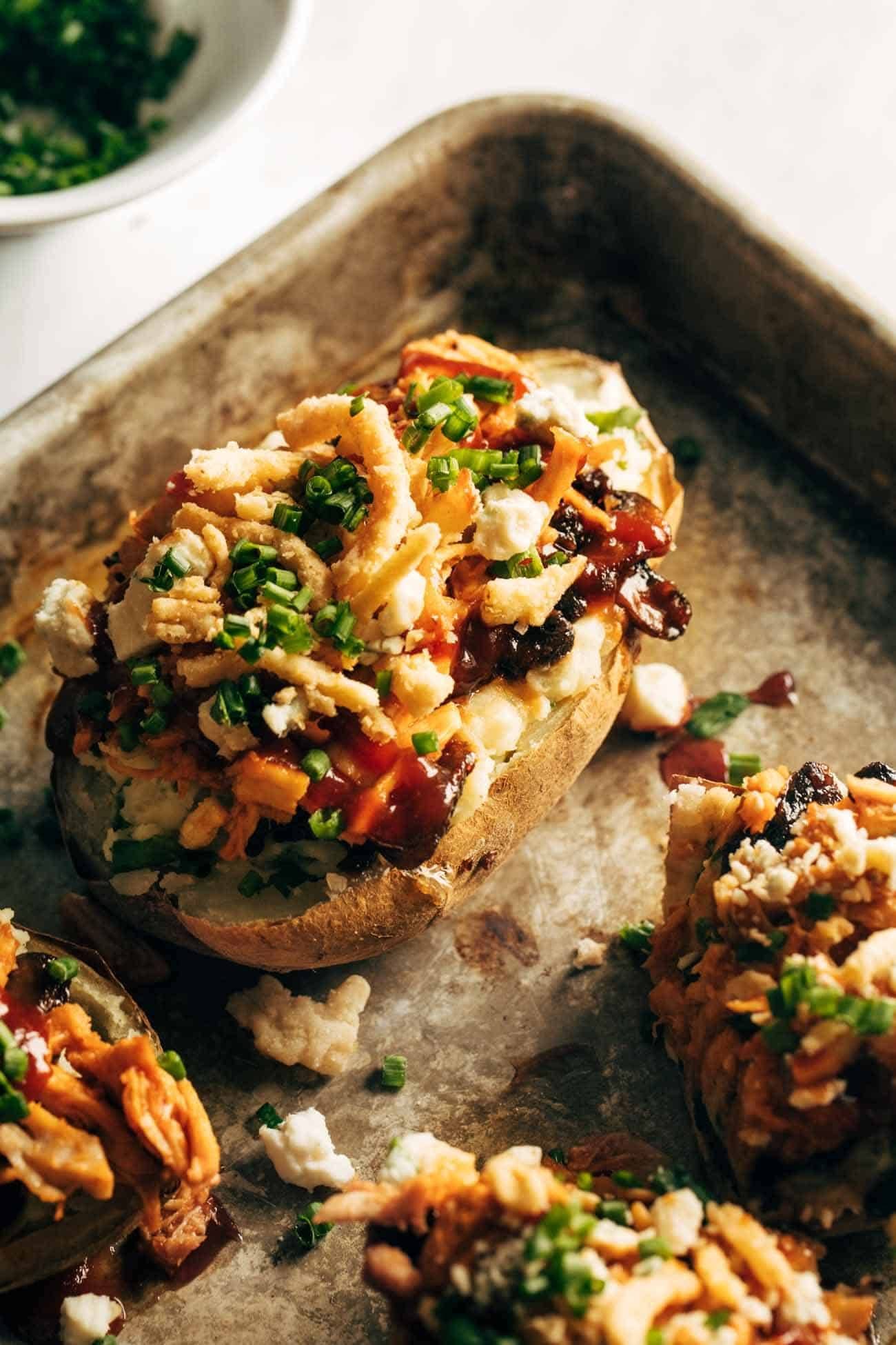 Close-up of Loaded BBQ Baked Potato on a sheet pan.