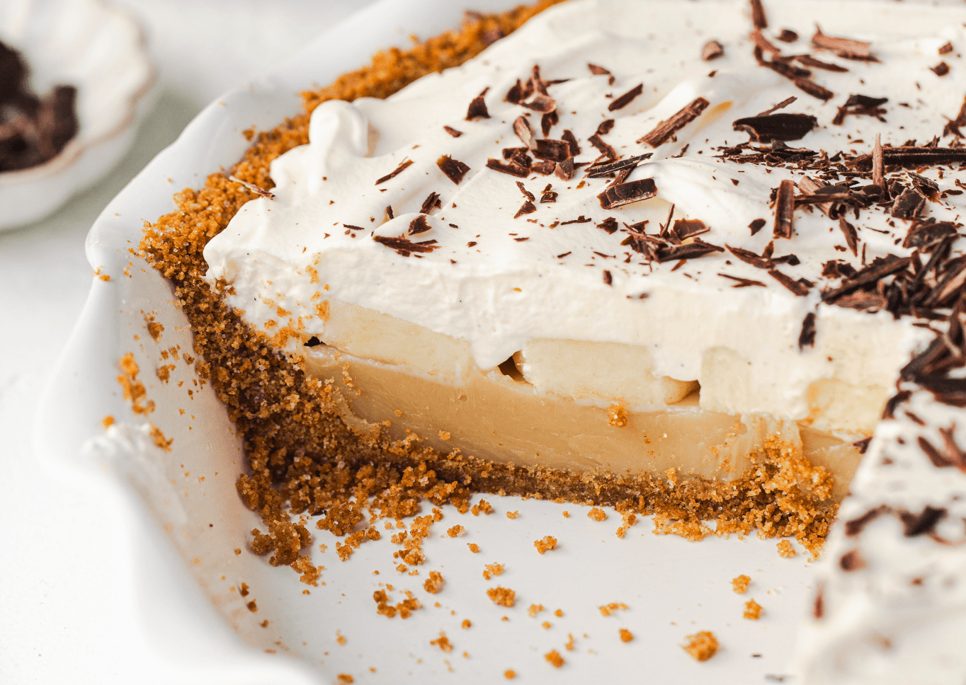 Sliced banoffee pie on a pie plate.