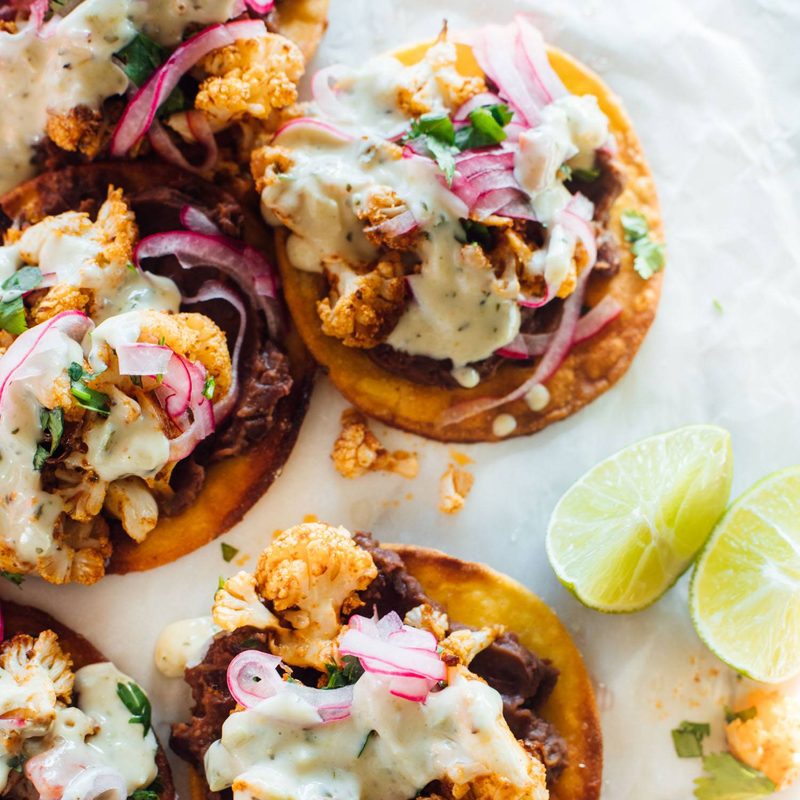 A picture of Cauliflower Black Bean Tostadas with Queso and Pickled Onion