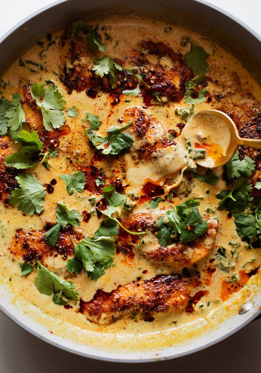 Chicken in a coconut sauce in a pan.