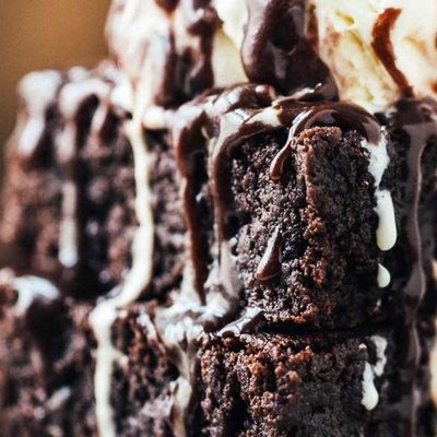 Extra Fudgy Coconut Oil Brownies on a plate with ice cream.
