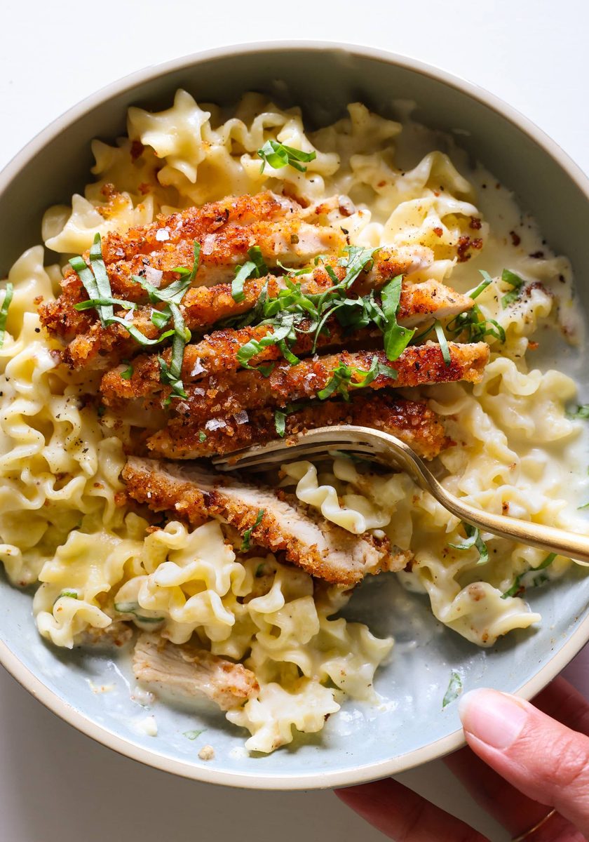 Creamy lemon pasta with chicken cutlet on top.