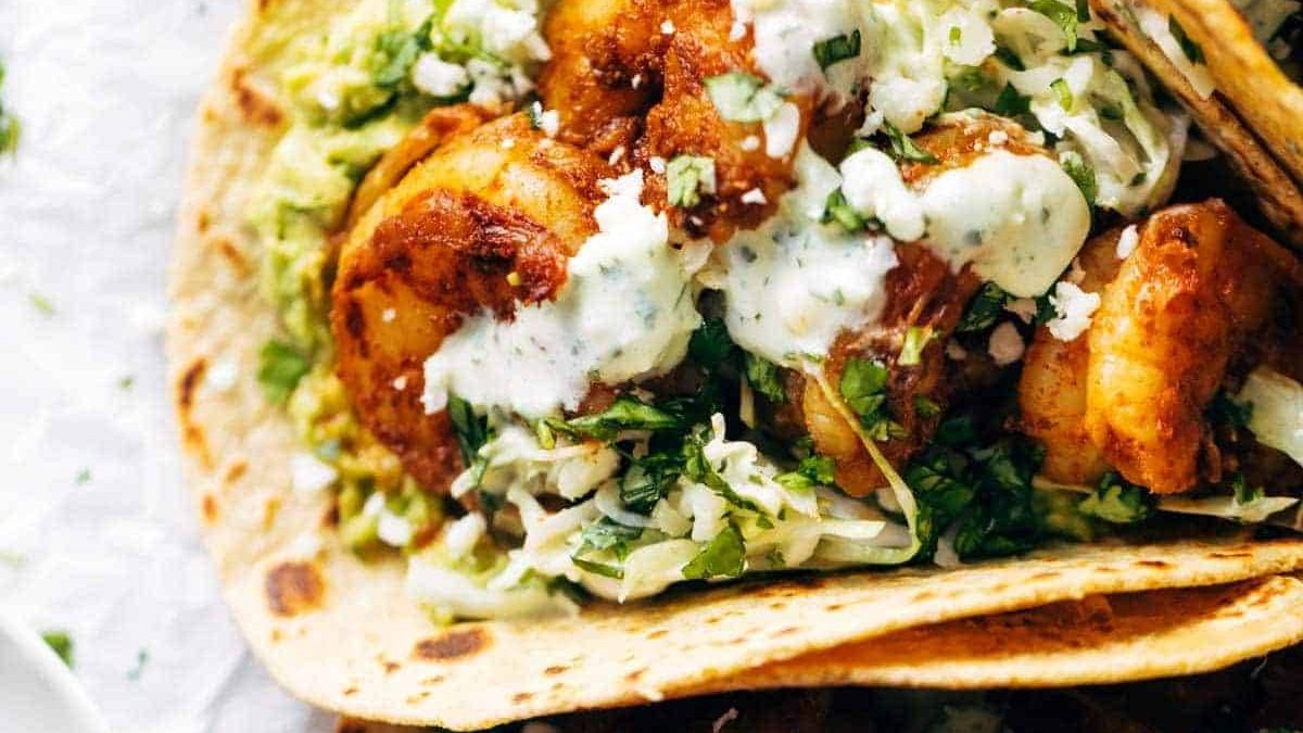 Shrimp tacos with sauce.