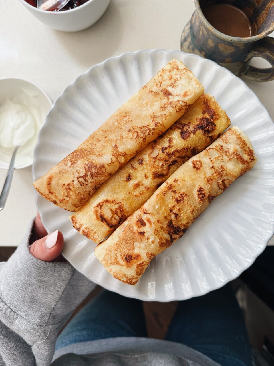 French toast crepes rolled on a plate.
