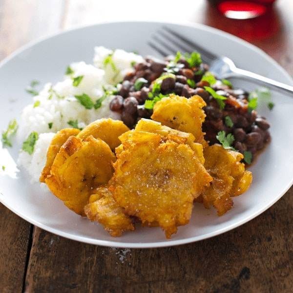 Garlic Tostones: Puerto Rican Fried Plantains with Rice and Beans