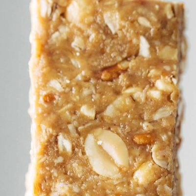 Granola bar being held by hand.