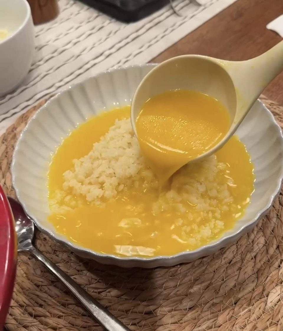 Pouring broth into a bowl with pastina.