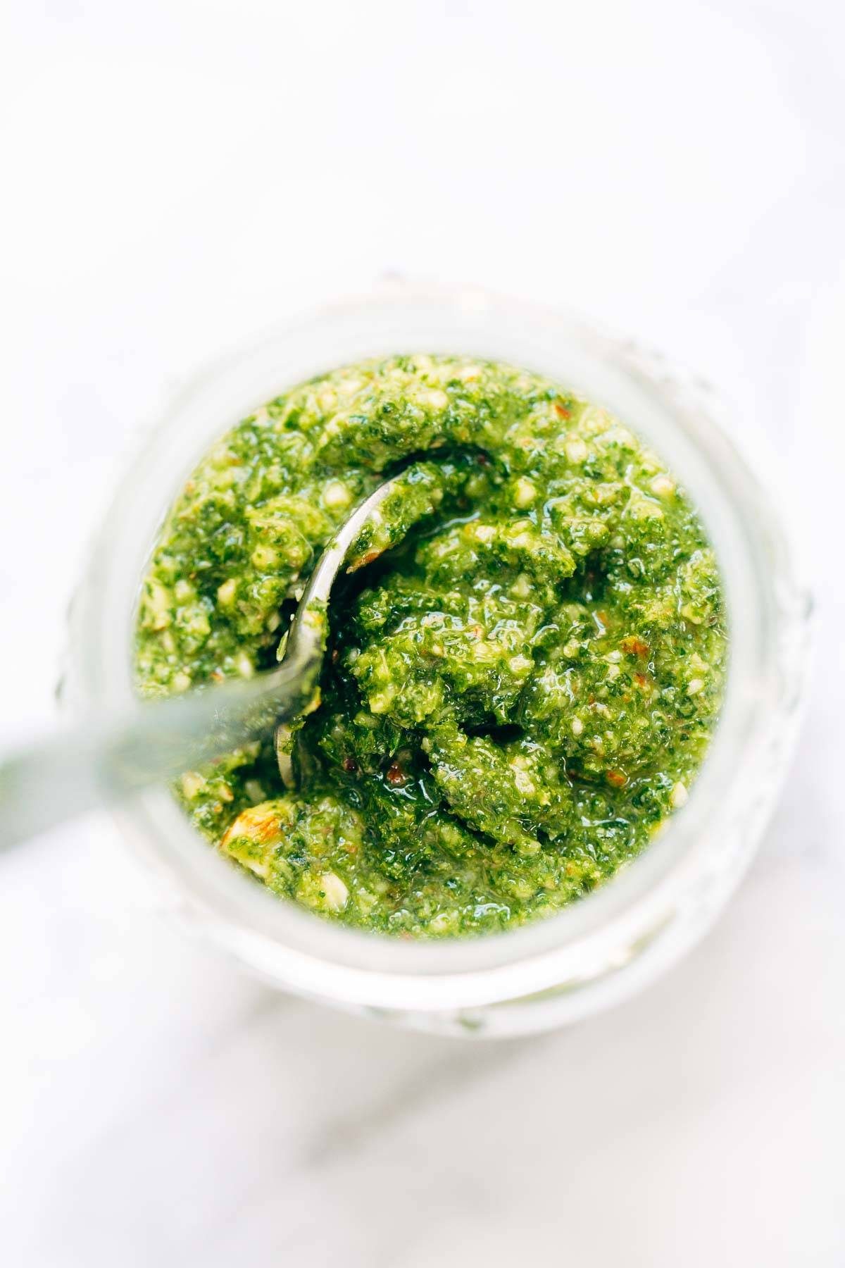 5 Minute Vegan Kale Pesto - made with almonds, olive oil, kale, garlic, salt, and lemon juice. Less than 150 calories per serving! | pinchofyum.com