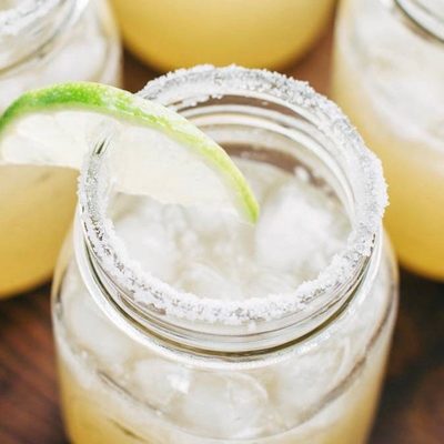 Margaritas for a Crowd in mason jars with lime.