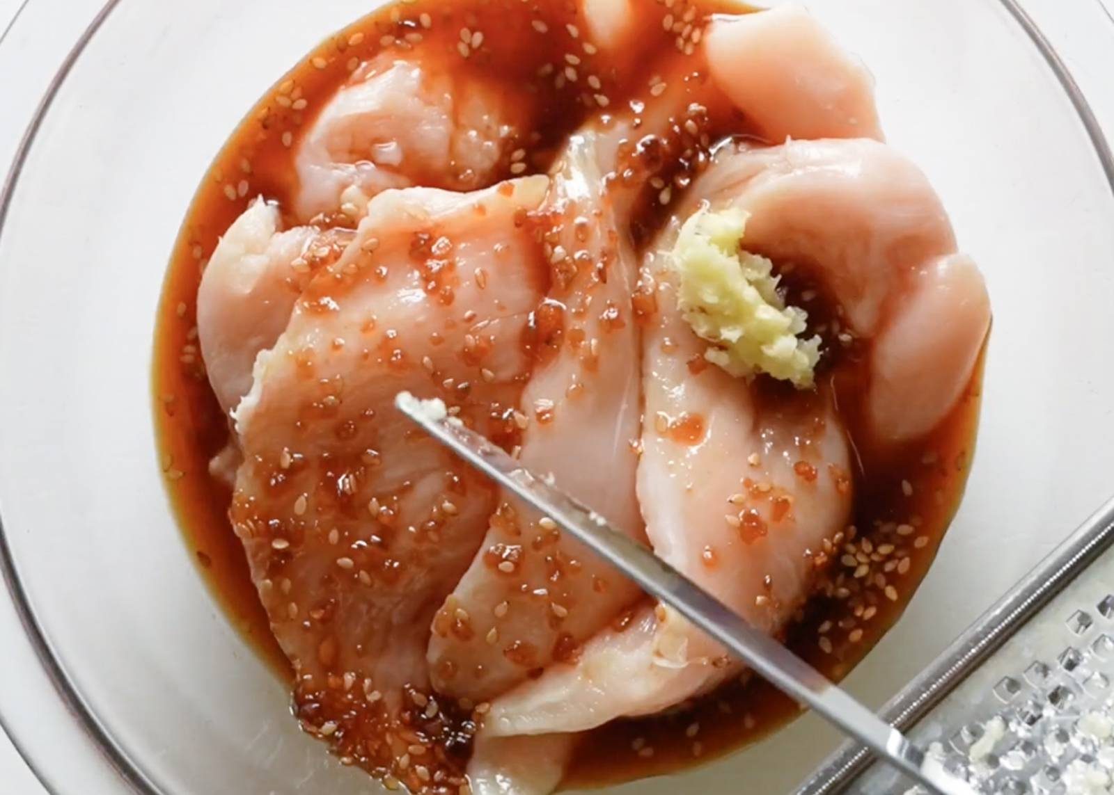 Marinating chicken in a bowl.