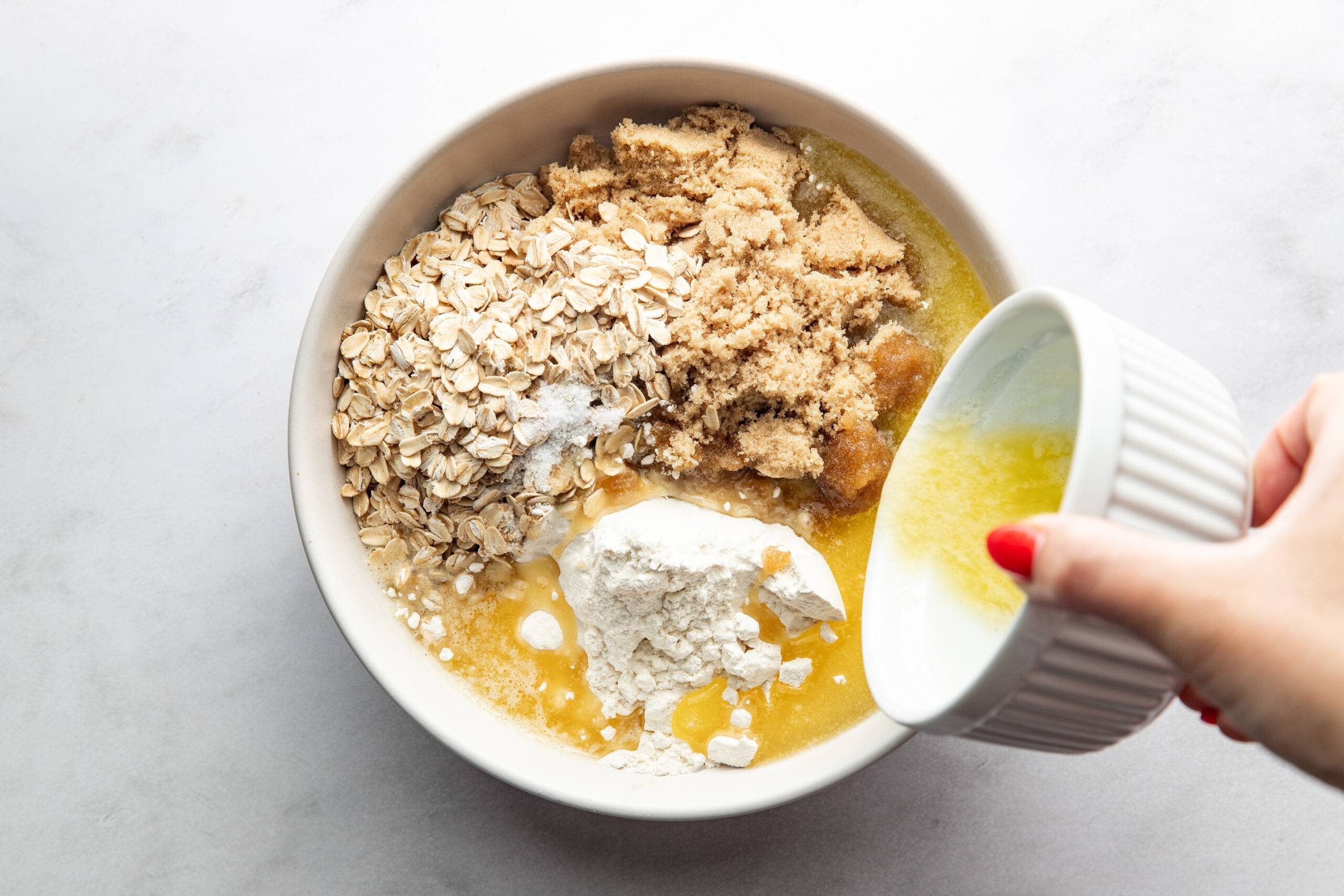 Mixing crumble in a bowl.