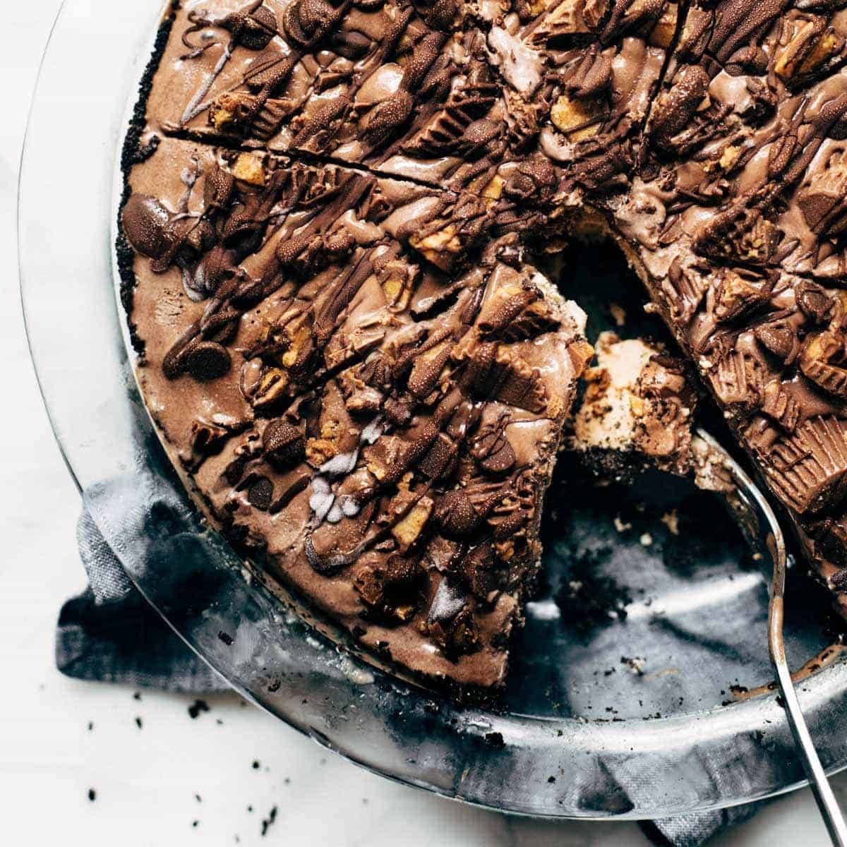 Peanut Butter Mocha Cake in a cake pan with a spatula.