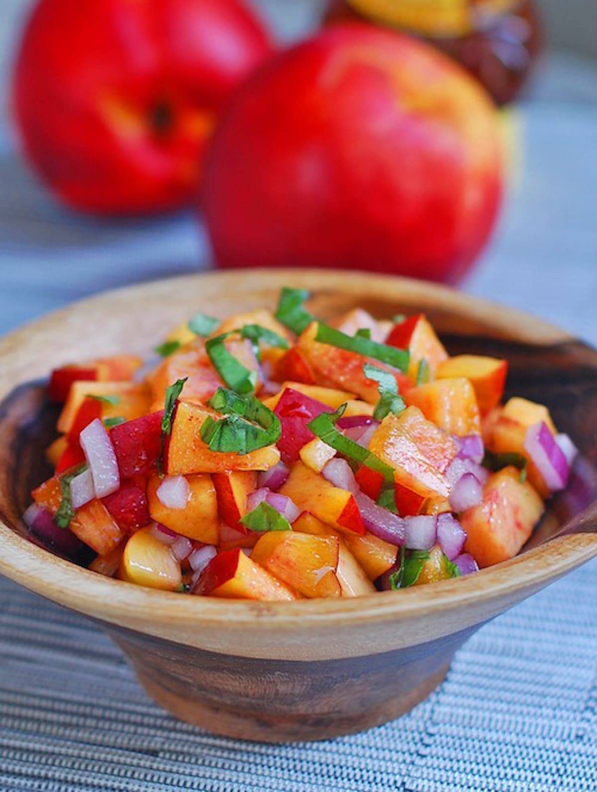 Nectarine basil salsa in a wooden bowl.