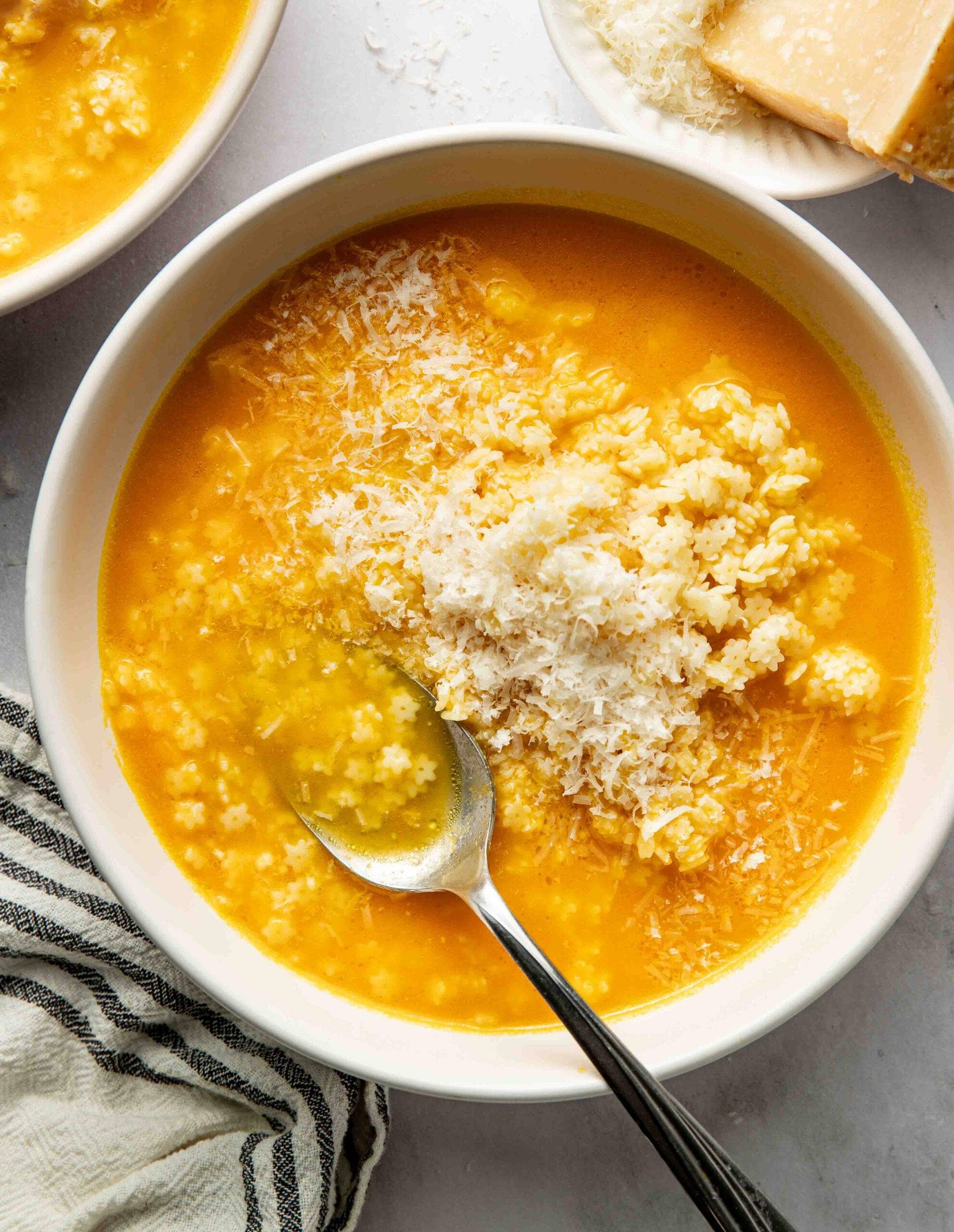Pastina Soup in a bowl topped with Parmesan