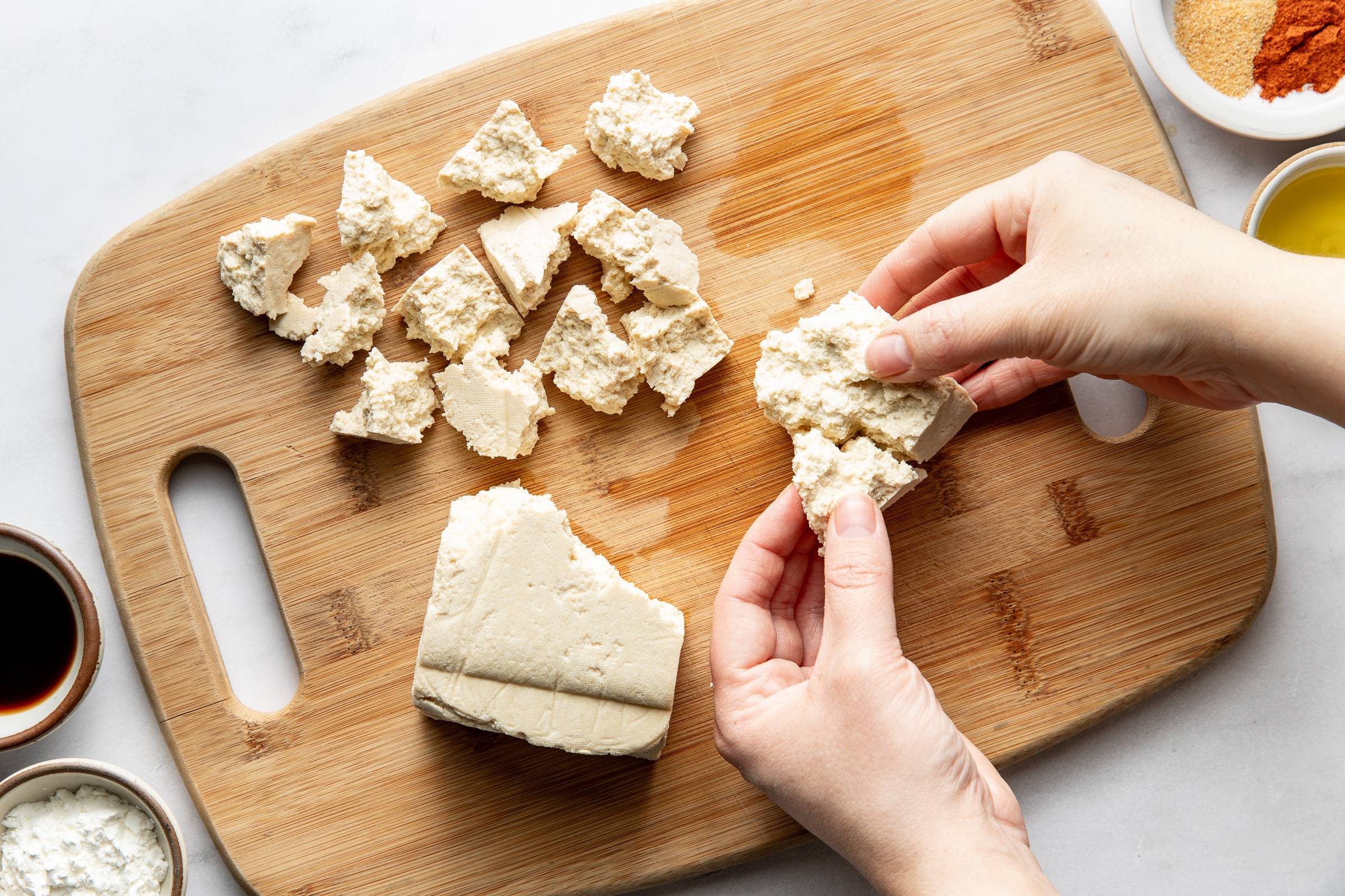 Pulling tofu into chunks.