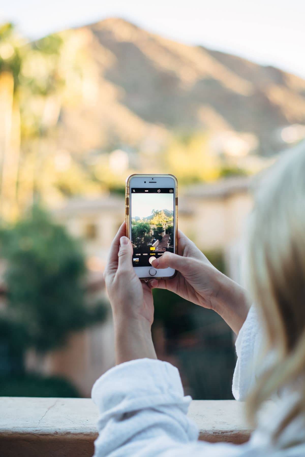iphone taking a photo of a mountain