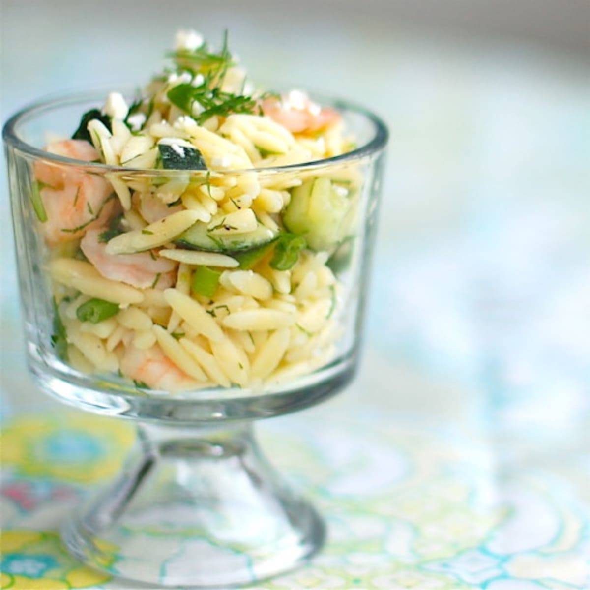 Shrimp and feta orzo in a glass dish.