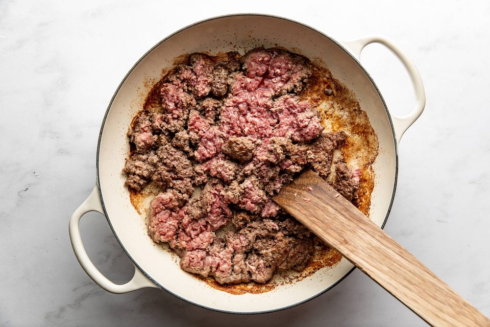 Browning beef in a Dutch oven.