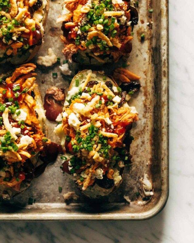 Loaded BBQ Baked Potatoes on a sheet pan.