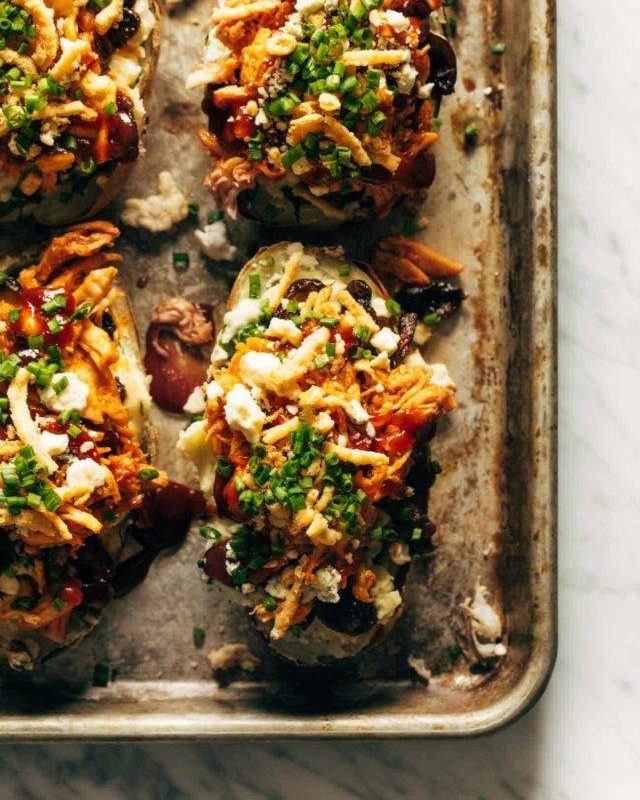 Loaded BBQ Baked Potatoes on a sheet pan.