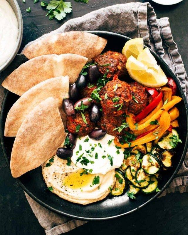 Harissa meatballs on a plate with whipped feta.