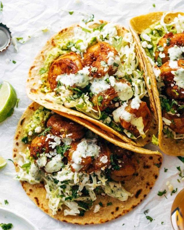 Spicy shrimp tacos with sauce.
