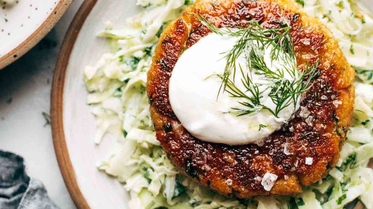 Salmon Burger on a plate with slaw.