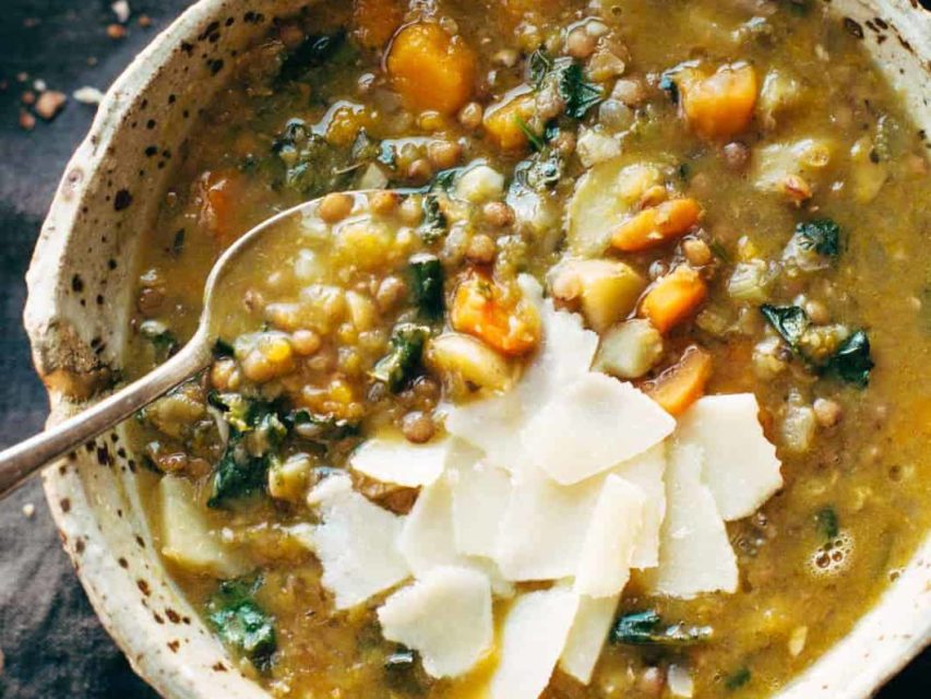 Detox Crockpot Lentil Soup in bowl with a spoon.