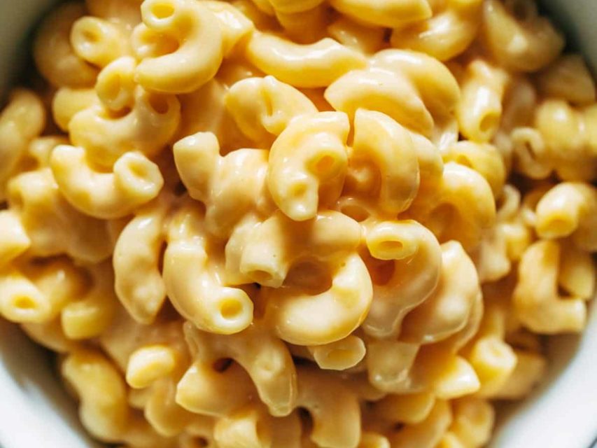 Mac and cheese piled high in a bowl.