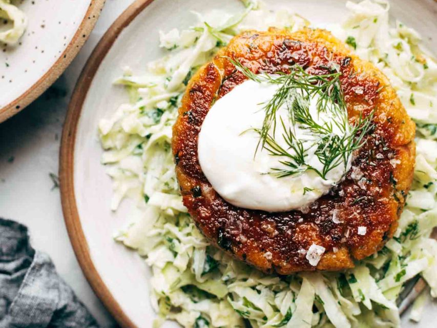 Salmon Burger on a plate with slaw.