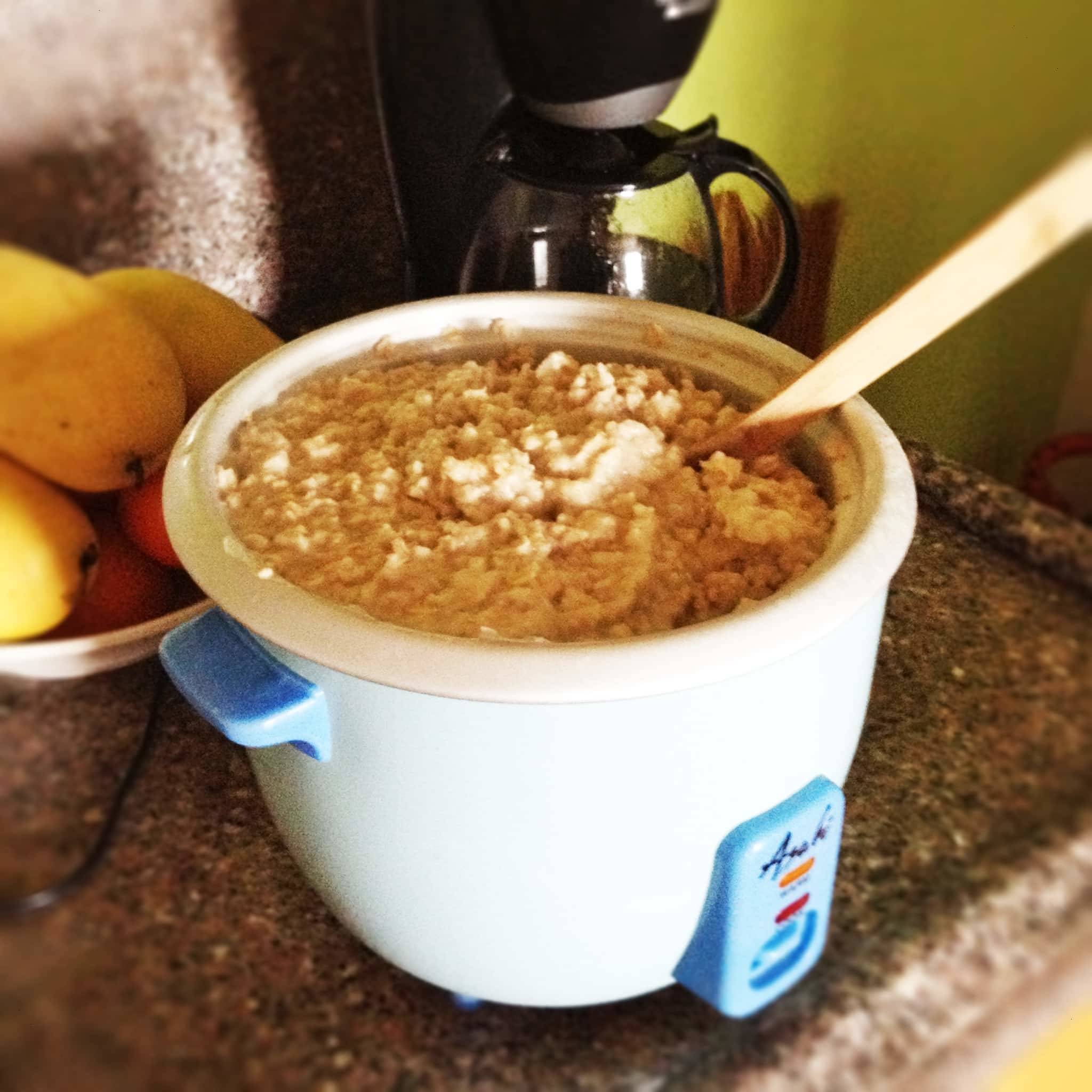 Oatmeal cooking with a wooden spoon.