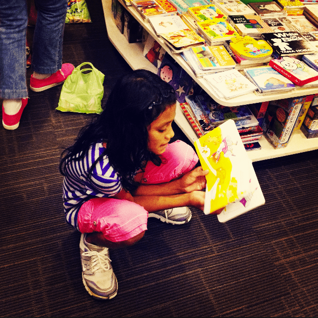 Young girl reading a book.