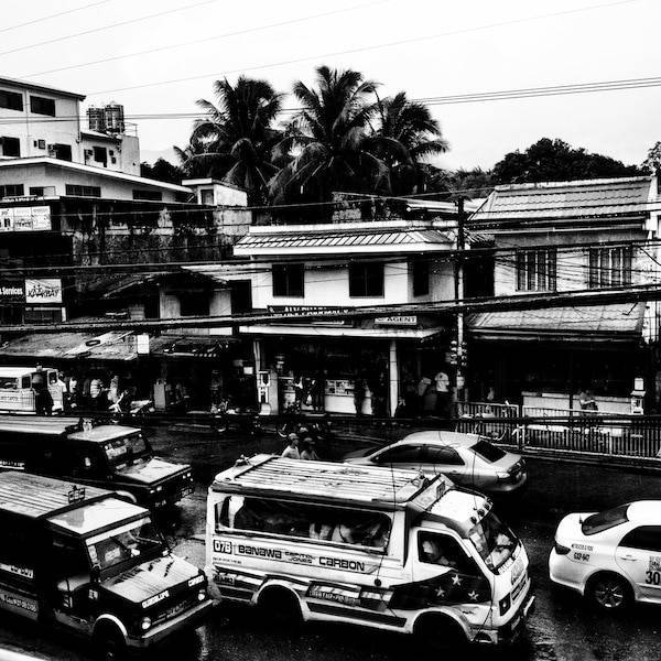 Black and white cars on a street.