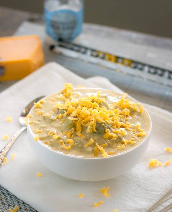 Crockpot Broccoli Cheese Soup with cheese topping on a napkin.