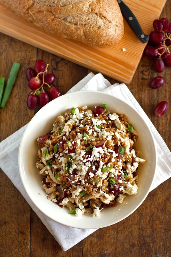 Bowl of honey chicken salad with grapes and feta.