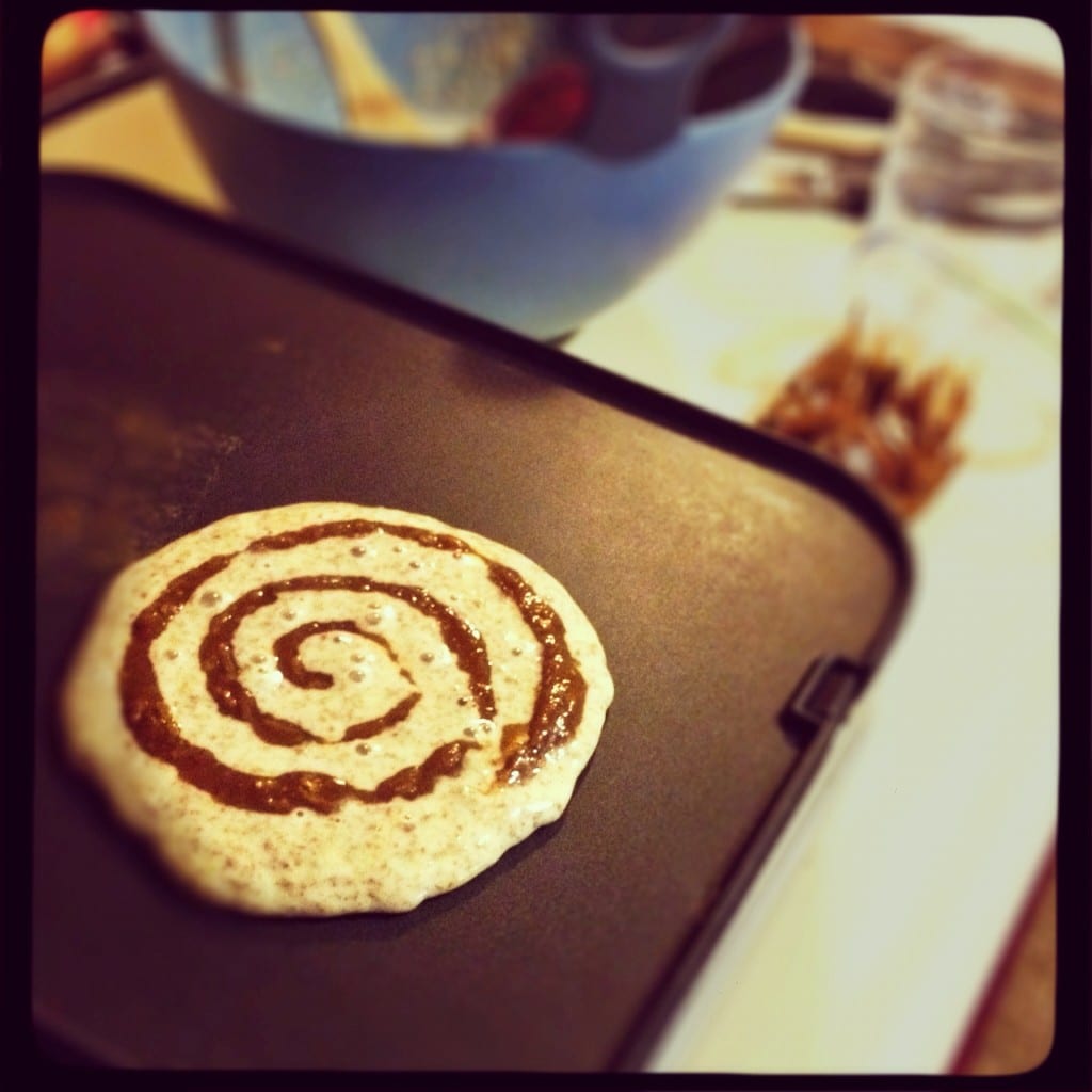 Pancake cooking on a skillet.