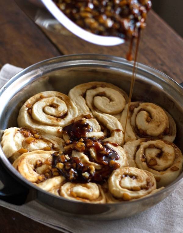 Caramel rolls drizzled with sticky apples and walnuts.