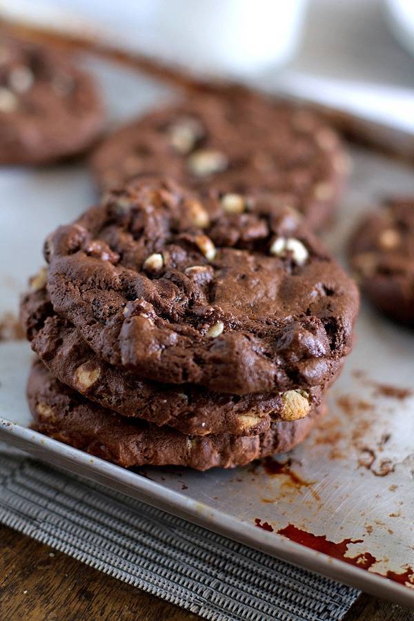 Double chocolate cake mix cookies stacked on a baking pan.