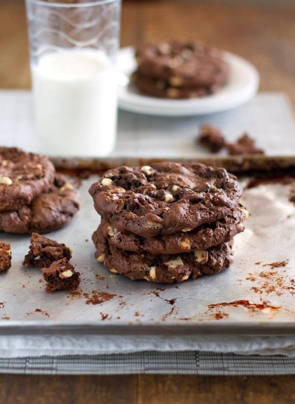 Double chocolate cake mix cookies stacked on a baking pan.