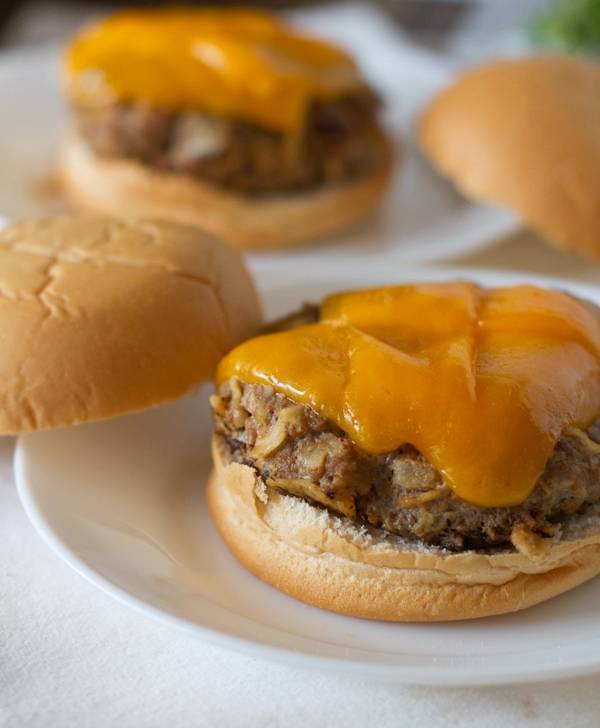 Open burger topped with cheese.
