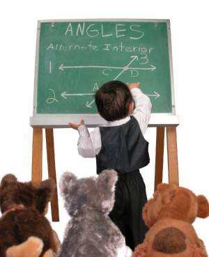 Young boy drawing on a chalk board.