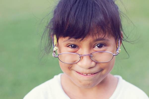 Young girl wearing glasses.
