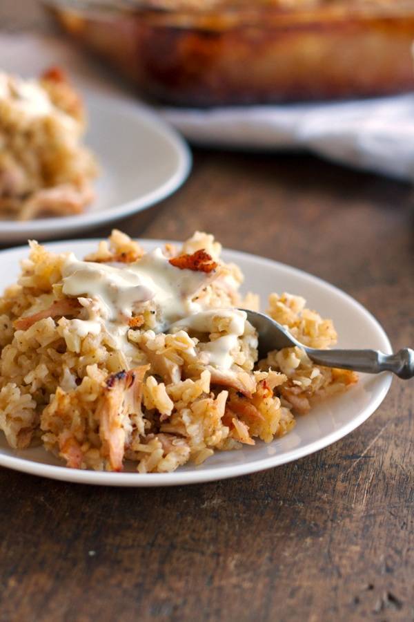 Chicken and rice casserole on a plate with a spoon.