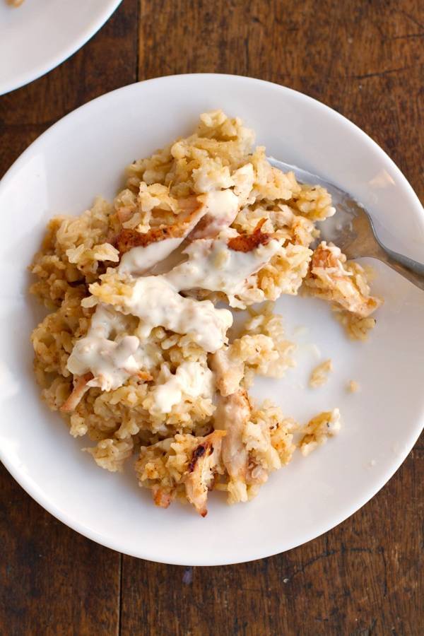 Chicken and rice casserole on a plate with a fork.